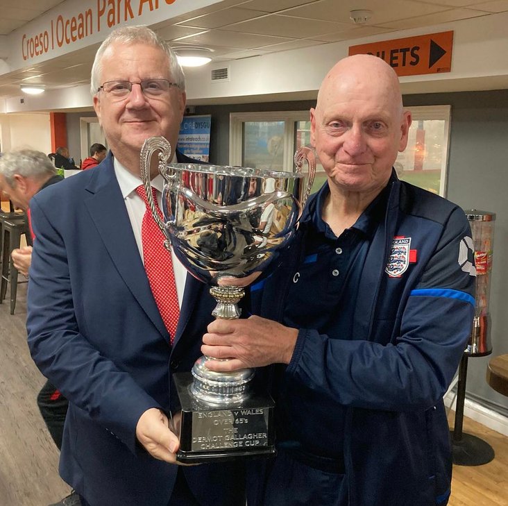 FAW vice-president, Mark Adams presents the Dermot Gallagher trophy to England captain, Peter Coffil, OPA, Nov 2025